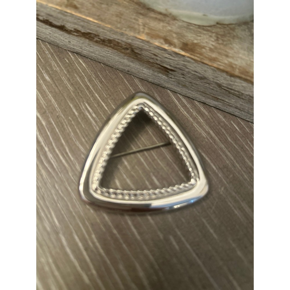 Monet triangle brooch with a‎ rope braid design.